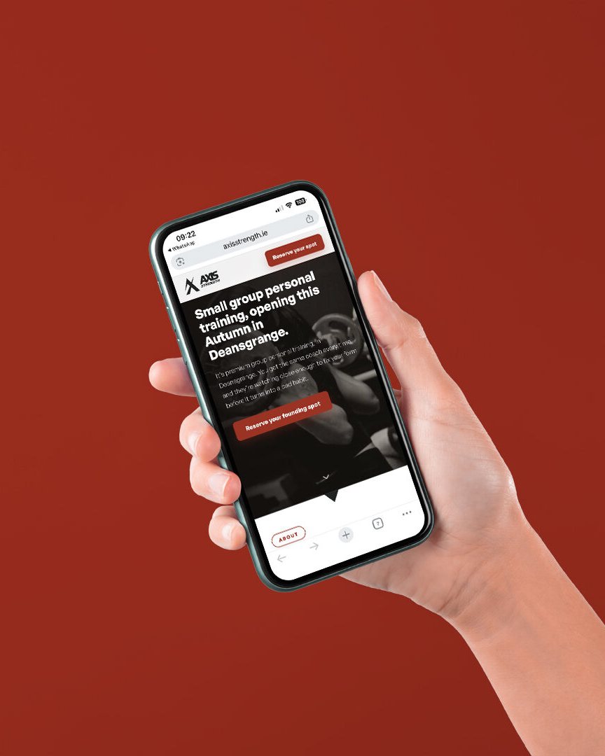 The Axis website open on a phone, held against a Rust background