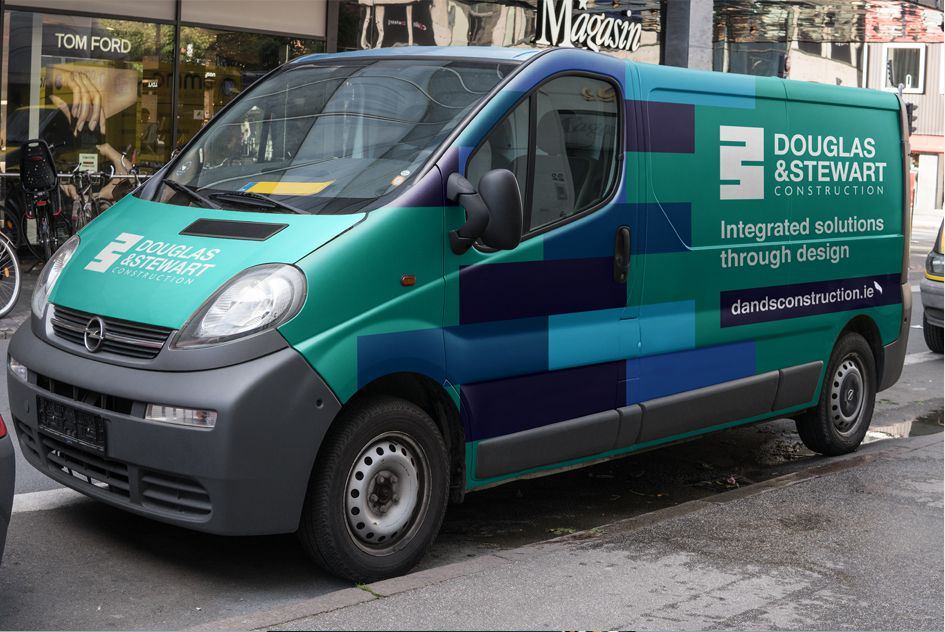 Douglas and Stewart van wrapped in the brick-course pattern with the line Integrated solutions through design