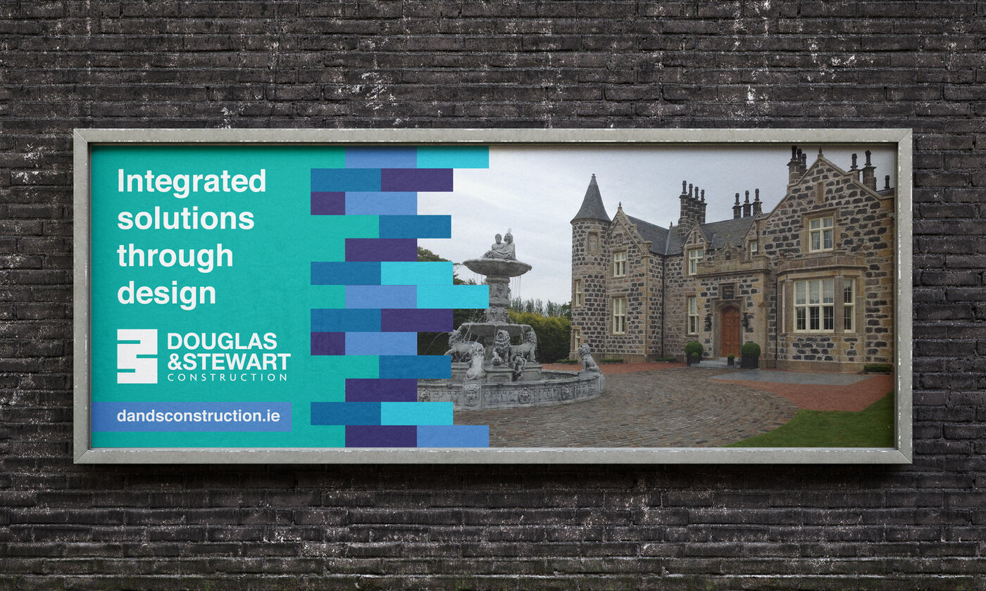 Douglas and Stewart billboard reading Integrated solutions through design, with the brick-course pattern