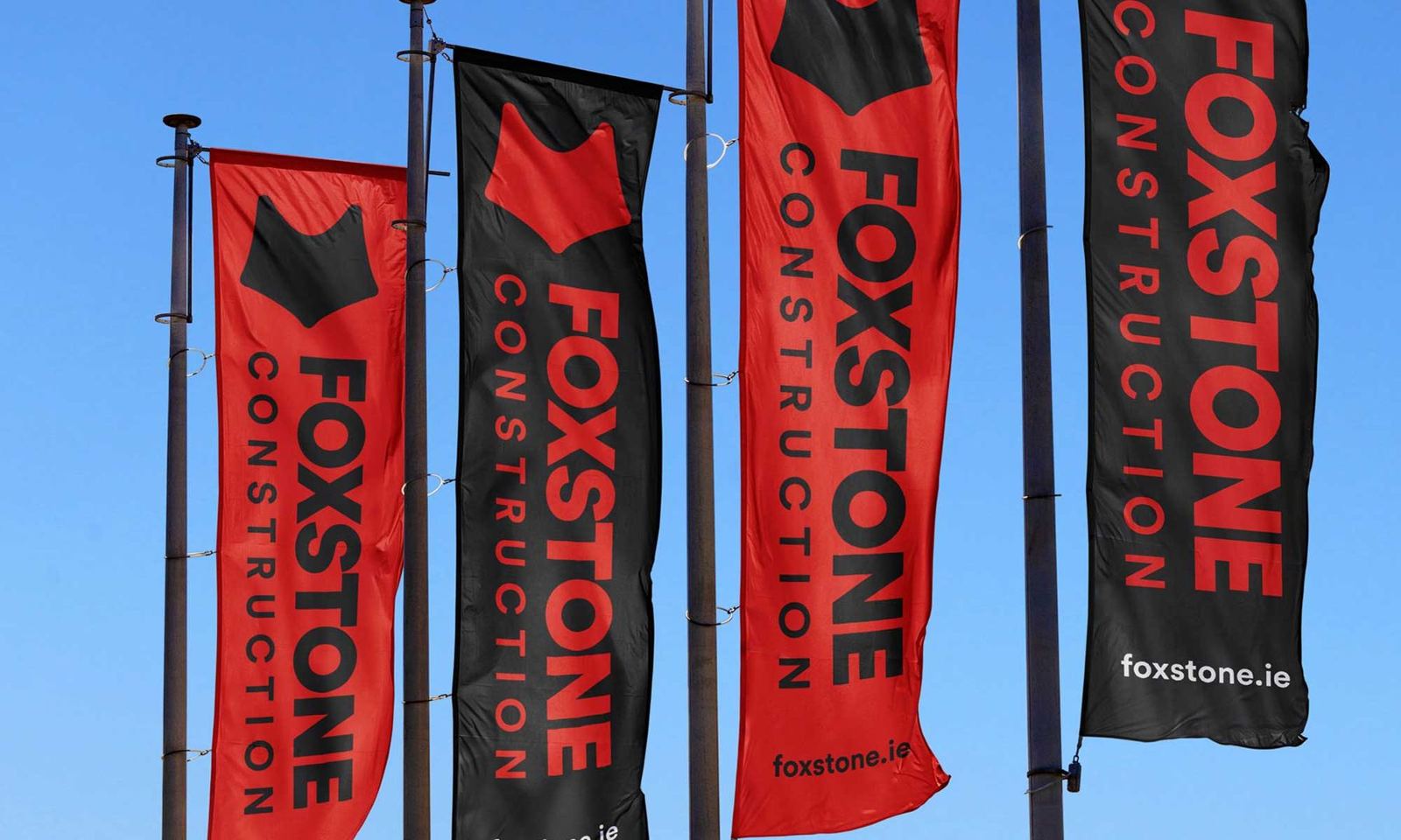 Red and black Foxstone flags on a building site