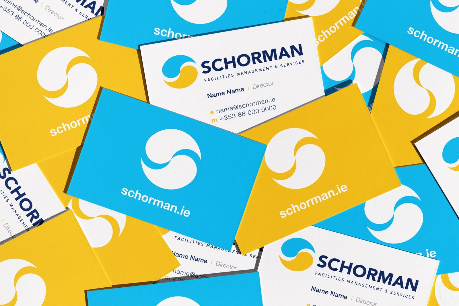 Schorman business cards in blue and yellow