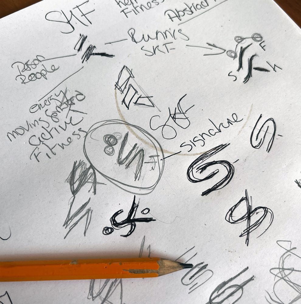 Pencil sketches exploring SK monograms and running figures