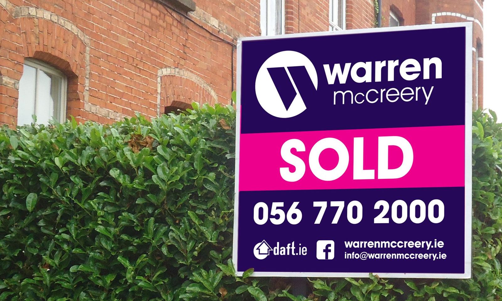 Warren McCreery Sold board in magenta and navy with a large phone number