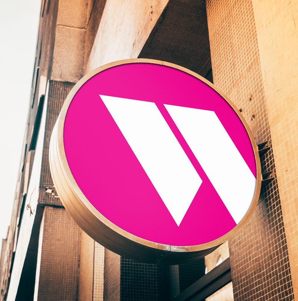Round Warren McCreery projecting sign on an office wall